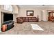 Living room with a large brown leather sectional sofa and tile floors at 3041 Bublin Bay Ave, North Las Vegas, NV 89081