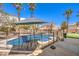 Inviting backyard oasis featuring a sparkling pool, patio furniture, and a shaded seating area at 3241 Rainmaker St, Las Vegas, NV 89129