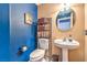 Small bathroom with pedestal sink and blue walls at 3241 Rainmaker St, Las Vegas, NV 89129