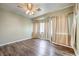 Bedroom with wood-look floors, ceiling fan, and bay window at 3241 Rainmaker St, Las Vegas, NV 89129