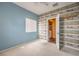 Bedroom with wood-like accent wall and laundry access at 3241 Rainmaker St, Las Vegas, NV 89129