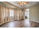 Spacious bedroom with wood-look flooring and ensuite bathroom at 3241 Rainmaker St, Las Vegas, NV 89129