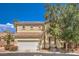 Two-story house with tan exterior, tile roof, and attached garage at 3241 Rainmaker St, Las Vegas, NV 89129