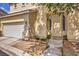 Home's front entrance with decorative door and landscaping at 3241 Rainmaker St, Las Vegas, NV 89129