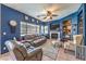 Gathering room with blue walls, fireplace, and leather furniture at 3241 Rainmaker St, Las Vegas, NV 89129