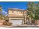 Two-story house with a white garage door and landscaping at 3241 Rainmaker St, Las Vegas, NV 89129