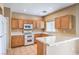 Bright kitchen features ample cabinetry and a breakfast bar at 3241 Rainmaker St, Las Vegas, NV 89129