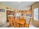 Kitchen with wooden cabinets, island, and breakfast nook at 3241 Rainmaker St, Las Vegas, NV 89129