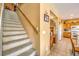 Carpeted stairs leading to upper level with kitchen view at 3241 Rainmaker St, Las Vegas, NV 89129