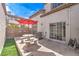 Private patio with table, umbrella, and artificial turf at 337 Seine Way # 0, Henderson, NV 89014