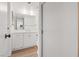 Bathroom featuring bright white cabinets, neutral countertop and laminate wood floors at 3823 S Maryland Pkwy # C3, Las Vegas, NV 89119