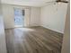 Bedroom with wood-look laminate flooring, neutral walls, a ceiling fan, and sliding door to the patio at 3823 S Maryland Pkwy # C3, Las Vegas, NV 89119