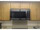 Black stainless steel microwave mounted above stove in updated kitchen at 3823 S Maryland Pkwy # C3, Las Vegas, NV 89119