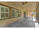 Covered patio with a ceiling fan and window shutters at 4165 Kerberos Ave, North Las Vegas, NV 89084