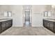 Double vanity bathroom with granite counters and a view down a hallway at 4165 Kerberos Ave, North Las Vegas, NV 89084