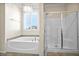 Bathroom features a soaking tub, walk-in shower, and granite vanity at 4165 Kerberos Ave, North Las Vegas, NV 89084