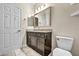 Bathroom with granite countertop, dark brown vanity, and tiled floor at 4165 Kerberos Ave, North Las Vegas, NV 89084