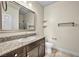 Bathroom features granite countertop, dark brown vanity, and tiled floor at 4165 Kerberos Ave, North Las Vegas, NV 89084