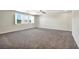 Spacious bedroom with carpet, ceiling fan, and large windows at 4165 Kerberos Ave, North Las Vegas, NV 89084