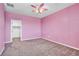 Pink bedroom with ceiling fan and carpet flooring at 4165 Kerberos Ave, North Las Vegas, NV 89084