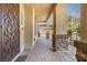 Covered patio entryway with stone columns and tile flooring at 4165 Kerberos Ave, North Las Vegas, NV 89084