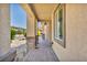 Covered patio walkway with stone columns and tile flooring at 4165 Kerberos Ave, North Las Vegas, NV 89084