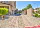 Brick driveway with a black wrought iron gate leading to the backyard at 4165 Kerberos Ave, North Las Vegas, NV 89084