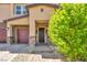 Front entrance with an ornate door, stonework and landscaping at 4165 Kerberos Ave, North Las Vegas, NV 89084