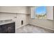 Laundry room with countertop, cabinets, and window at 4165 Kerberos Ave, North Las Vegas, NV 89084