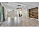 Open living area with tile floors, staircase, and wood accent wall at 4165 Kerberos Ave, North Las Vegas, NV 89084