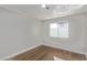 Comfortable bedroom with wood-look flooring and a bright, sunlit window at 4321 Mott Cir, Las Vegas, NV 89102