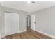 Bedroom with wood-look flooring, closet with sliding doors, and modern lighting at 4321 Mott Cir, Las Vegas, NV 89102