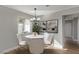 Bright dining area with modern lighting, neutral paint, and a view to the green backyard at 4321 Mott Cir, Las Vegas, NV 89102