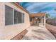 View of the house and patio area with covered pergola and desert rock landscape at 4507 Golden Palomino Ln, North Las Vegas, NV 89032