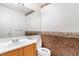 Simple bathroom with wood vanity and floral wall accents at 4507 Golden Palomino Ln, North Las Vegas, NV 89032