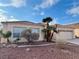 Tan house with tile roof, palm trees, and rock landscaping at 4507 Golden Palomino Ln, North Las Vegas, NV 89032