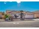 House exterior with tile roof, two-car garage, and mature landscaping at 4507 Golden Palomino Ln, North Las Vegas, NV 89032