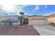 One-story house with tile roof, desert landscaping, and two-car garage at 4507 Golden Palomino Ln, North Las Vegas, NV 89032