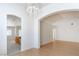 Hallway view featuring an elegant chandelier, arched doorways, and hardwood-style flooring at 4507 Golden Palomino Ln, North Las Vegas, NV 89032