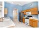 Kitchen with wood cabinets, stainless steel appliances, and tiled floors at 4507 Golden Palomino Ln, North Las Vegas, NV 89032