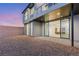 Modern home featuring expansive sliding glass doors opening to a private backyard with desert landscaping at 506 Overlook Rim Dr, Henderson, NV 89012