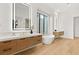 Modern bathroom featuring a standalone tub, dual vanities, and sleek fixtures at 506 Overlook Rim Dr, Henderson, NV 89012