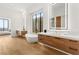 Modern bathroom boasting dual vanities, a soaking tub, and bright lighting at 506 Overlook Rim Dr, Henderson, NV 89012