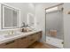 Modern bathroom with dual sinks, sleek countertops, and a glass-enclosed shower at 506 Overlook Rim Dr, Henderson, NV 89012