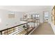 Spacious hallway with modern railings, neutral tones, and natural light, offering a view of the city at 506 Overlook Rim Dr, Henderson, NV 89012