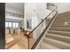 Bright, contemporary home featuring a staircase with sleek railings and a view of the open-concept living area at 506 Overlook Rim Dr, Henderson, NV 89012