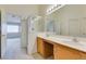 Bright bathroom features a double sink vanity with wood cabinets and a glass shower at 5582 Little Lake Ave, Las Vegas, NV 89122