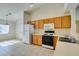 Bright kitchen features oak cabinets, white appliances, and tile flooring at 5582 Little Lake Ave, Las Vegas, NV 89122