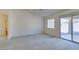 Carpeted living room with sliding glass doors, offering access to outdoor space and natural light at 5582 Little Lake Ave, Las Vegas, NV 89122