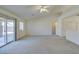 Sun-filled living room with carpet, vaulted ceilings, and sliding glass doors to the patio area at 5582 Little Lake Ave, Las Vegas, NV 89122